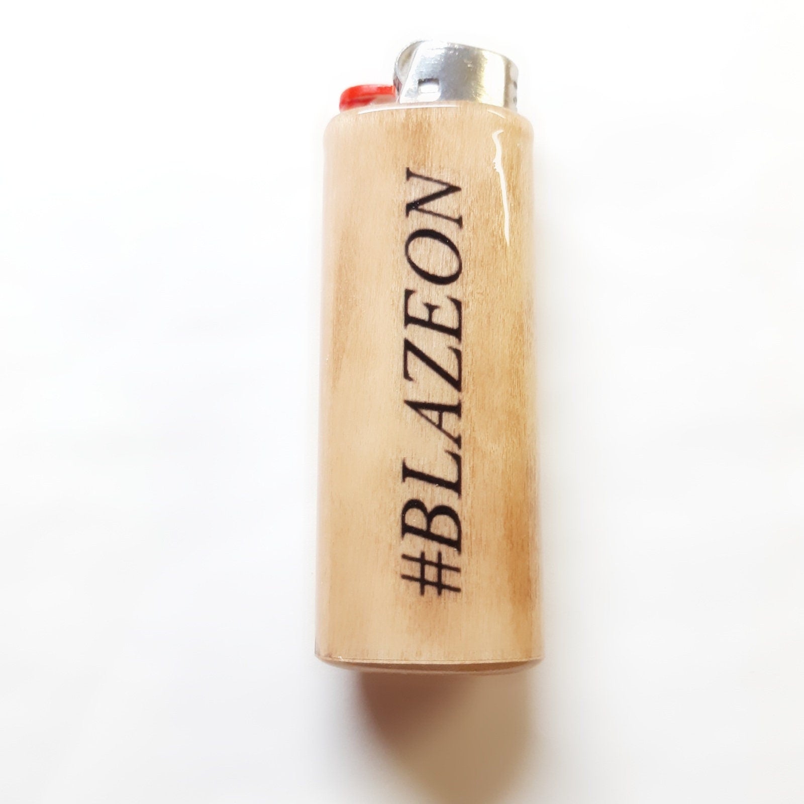 Wooden lighter with '#BLAZEON' branding on a white background