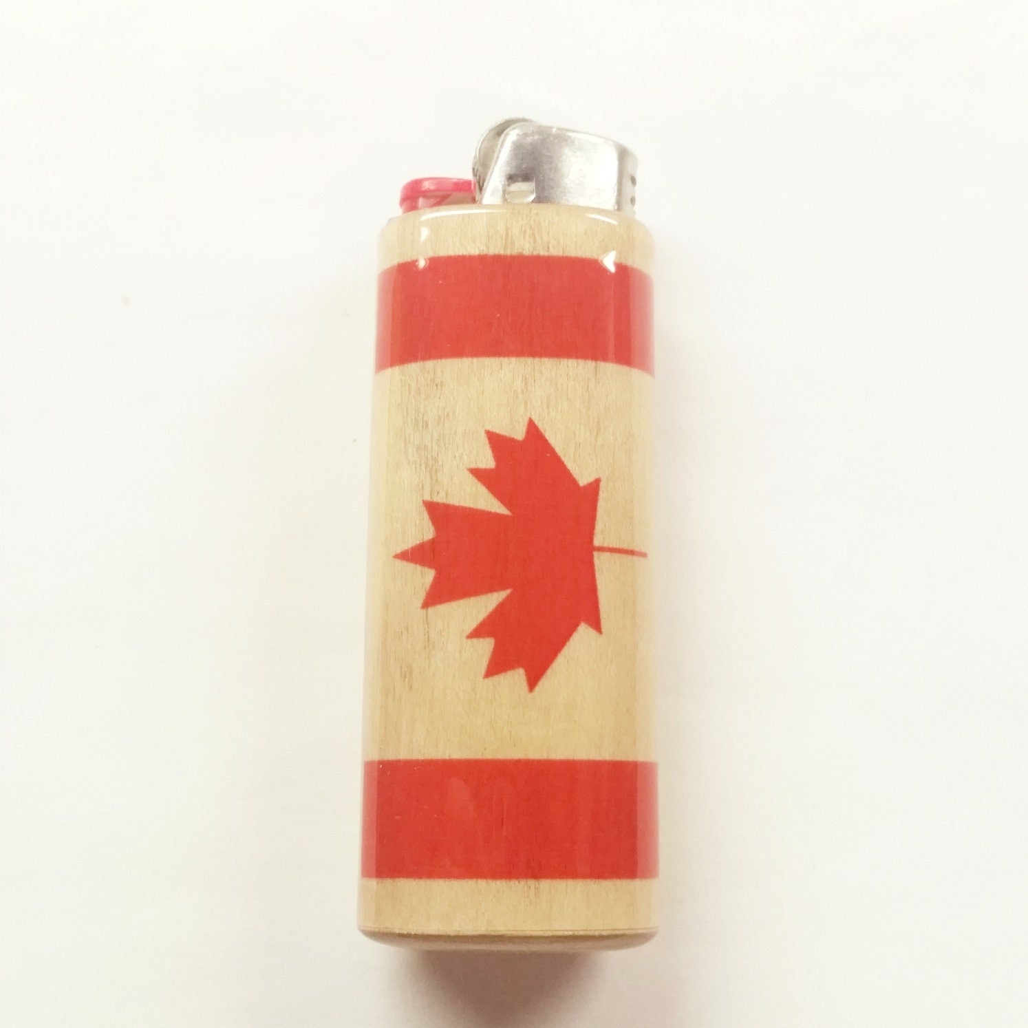 Lighter with a red maple leaf design Canadian Flag on a beige background