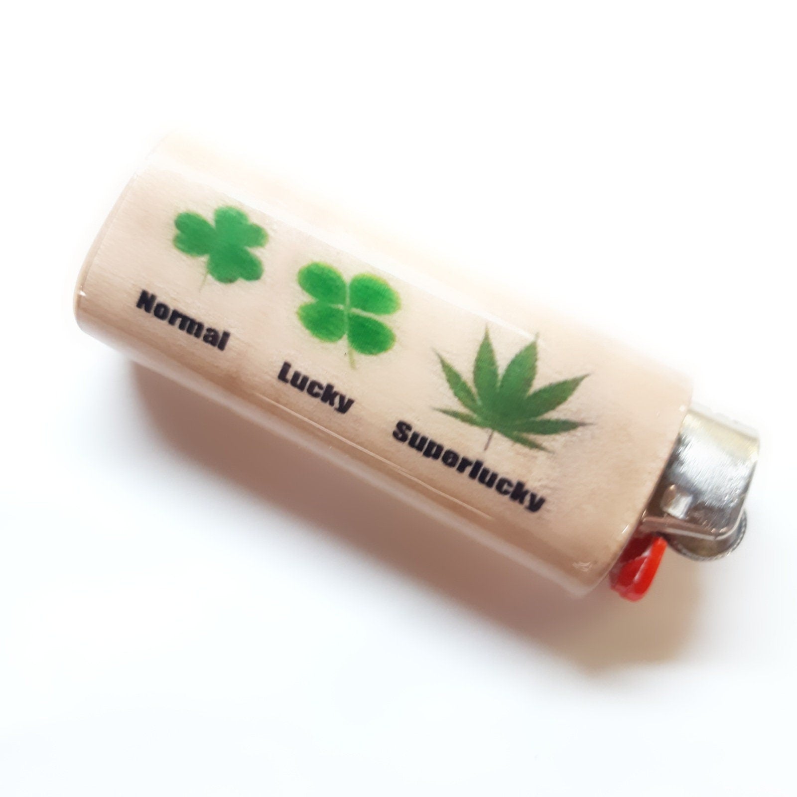 Lighter with four-leaf clover and cannabis leaf labels on a white background