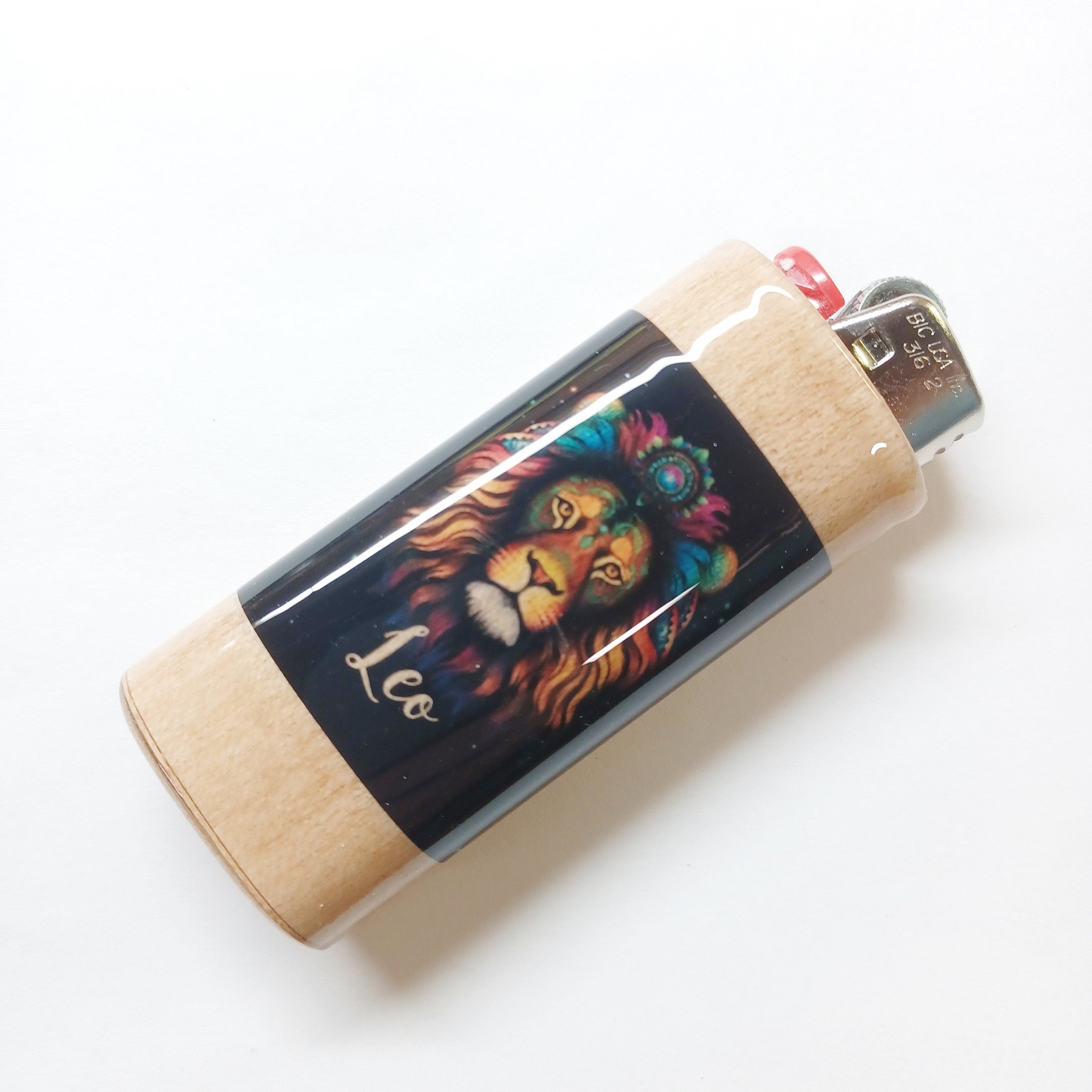 Lighter with a colorful lion design on a white background