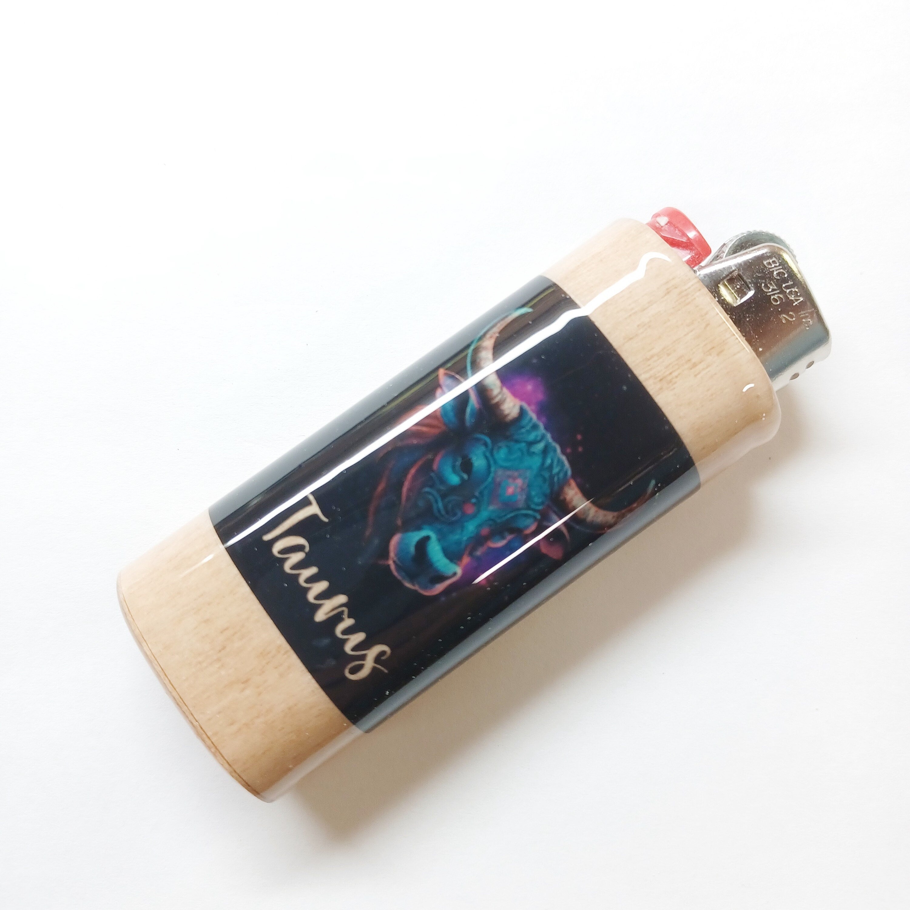Lighter with Taurus zodiac design on a white background