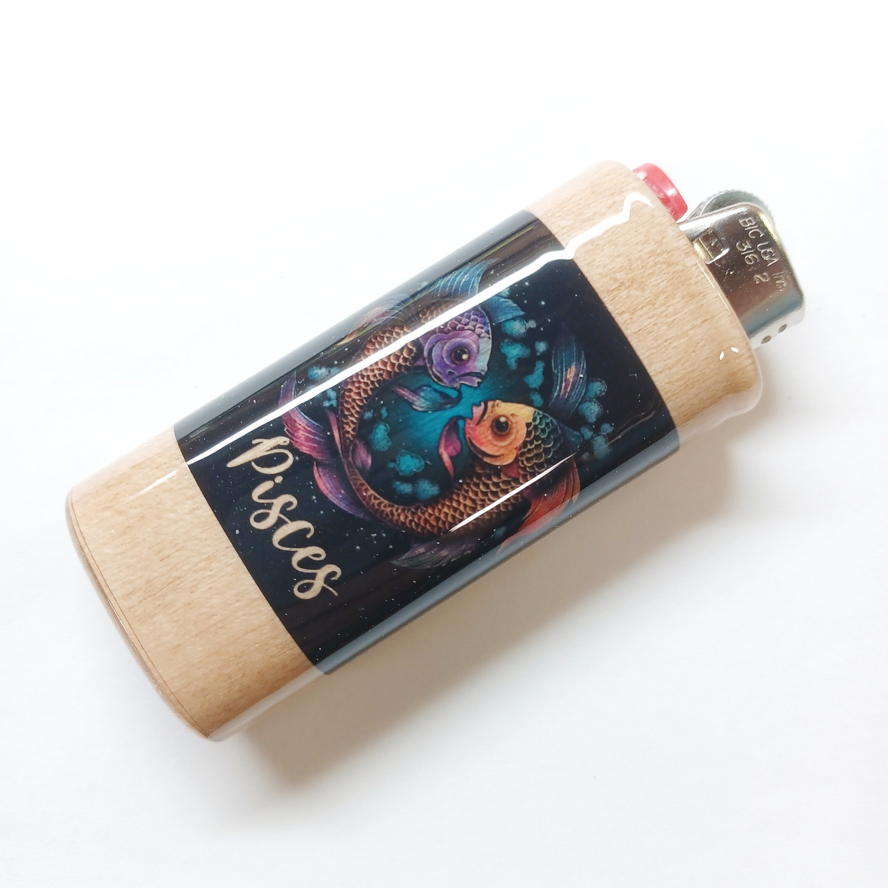 Lighter with Pisces zodiac design on a white background