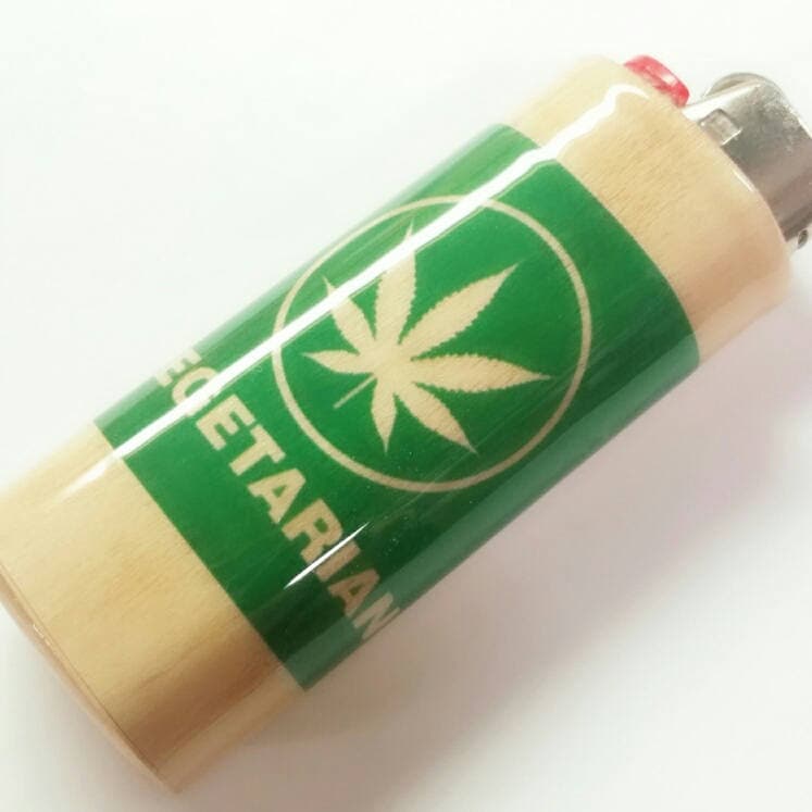 Lighter with a green label featuring a cannabis leaf on a white background