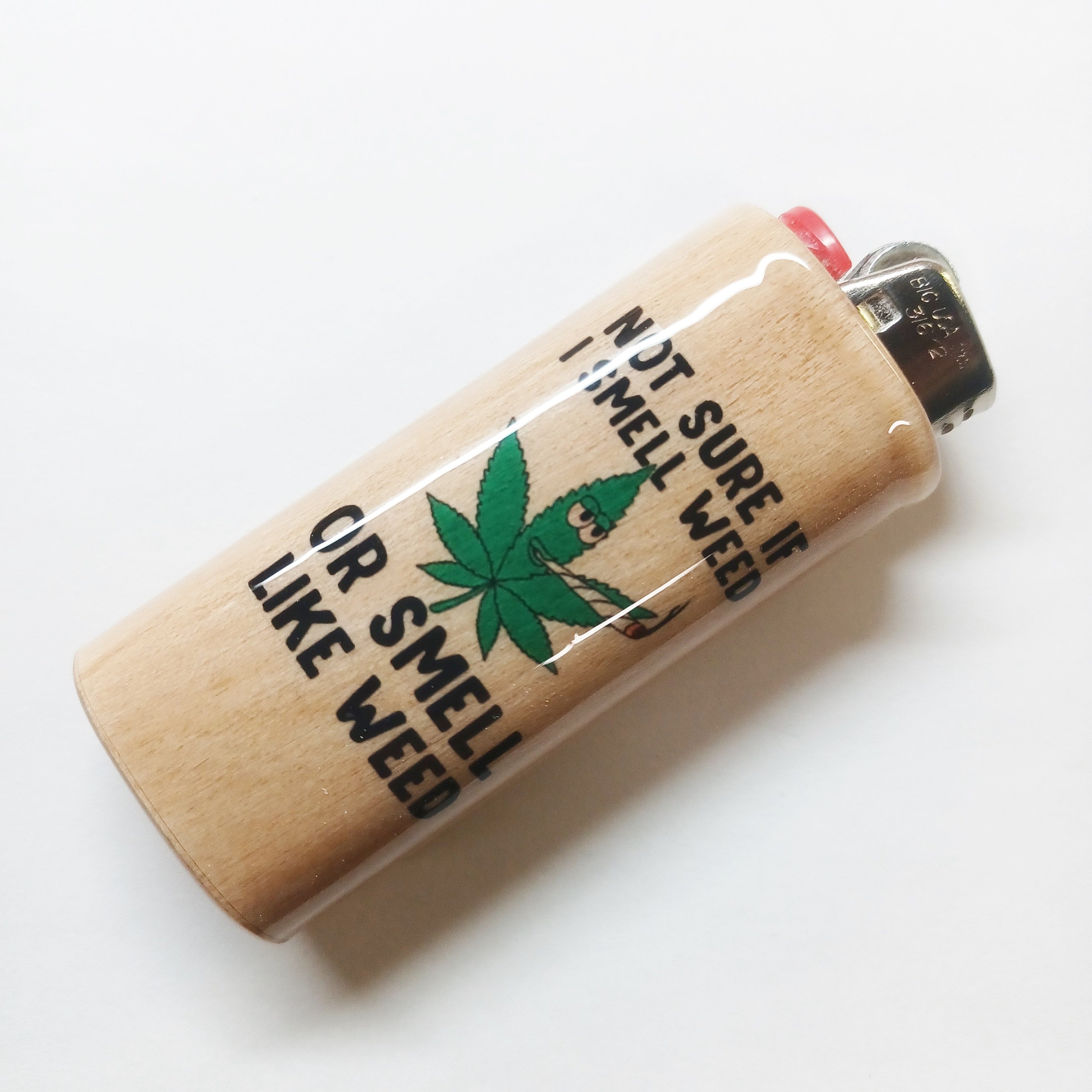 Lighter with pot leaf graphic and text on a white background