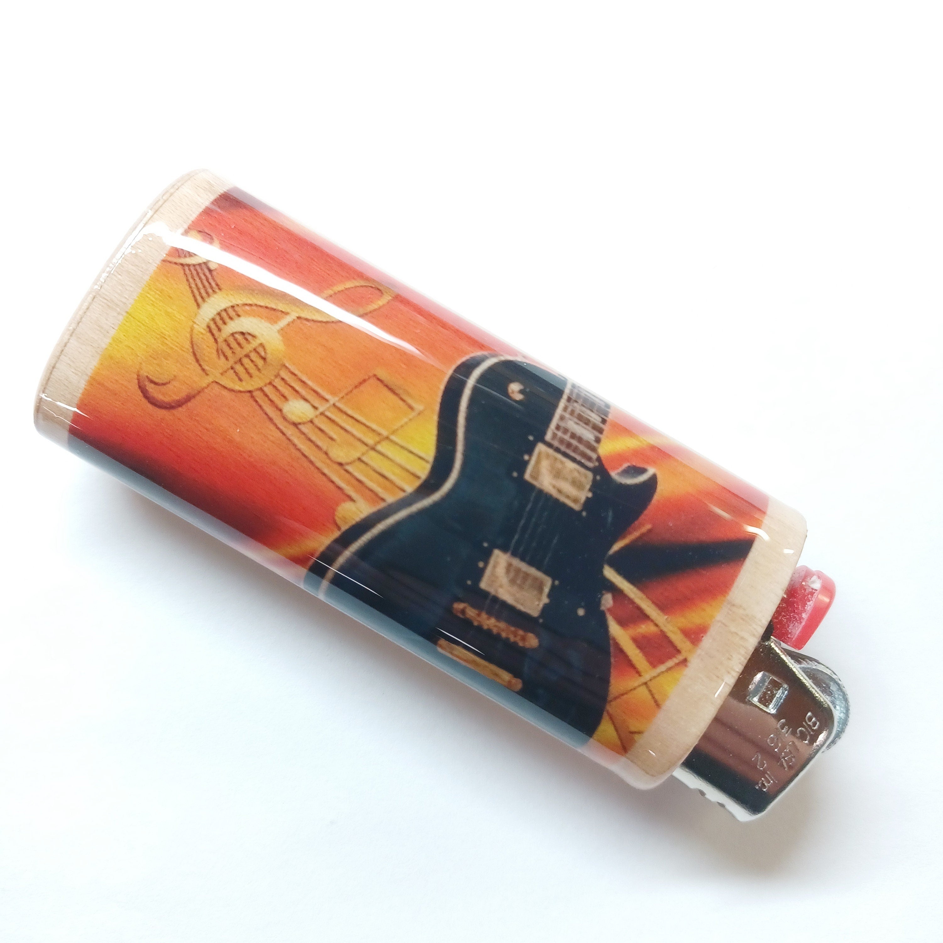 Lighter case with guitar design on a white background