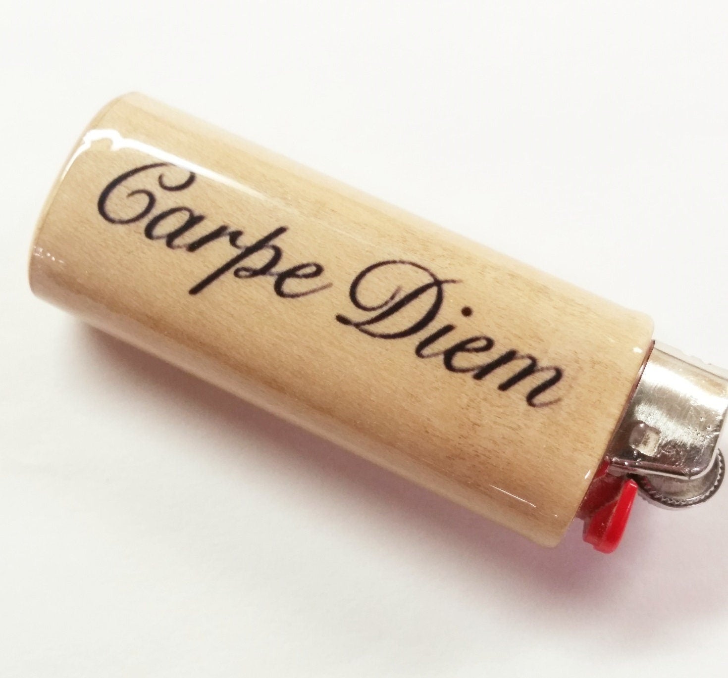 Lighter with 'Carpe Diem' engraving on a white background
