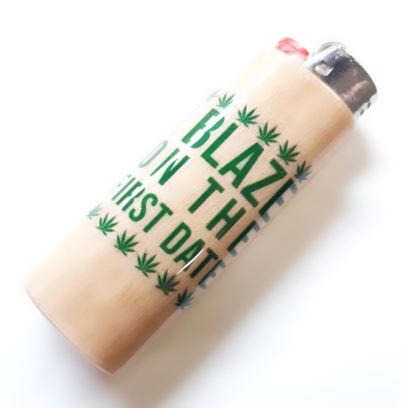 Lighter with 'Blaze in the D' text and green leaf patterns on a white background