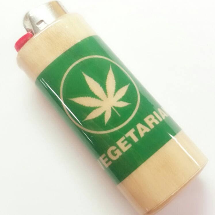 Lighter with a cannabis leaf design and 'Vegetarian' text on a white background