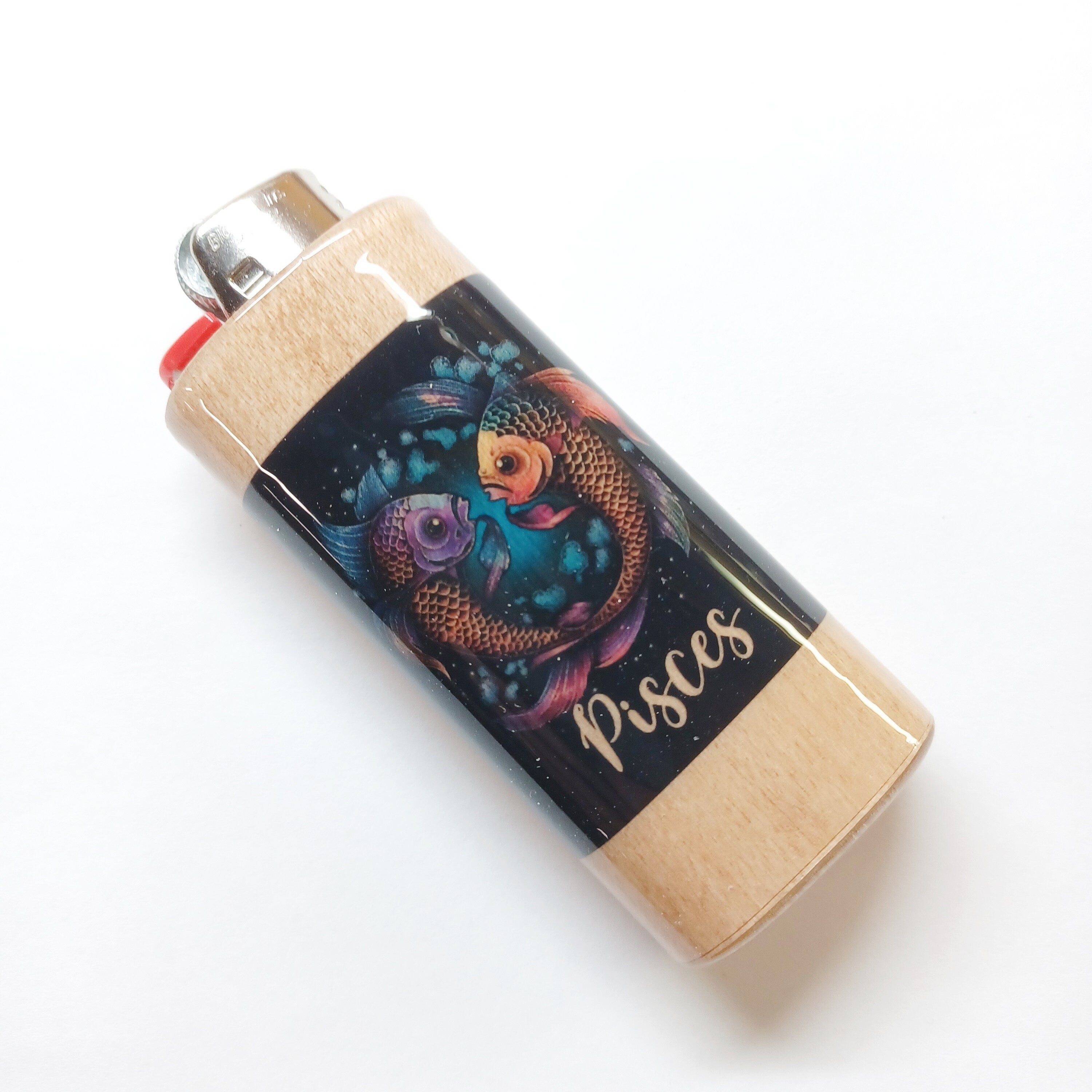 Lighter with Pisces design on a white background