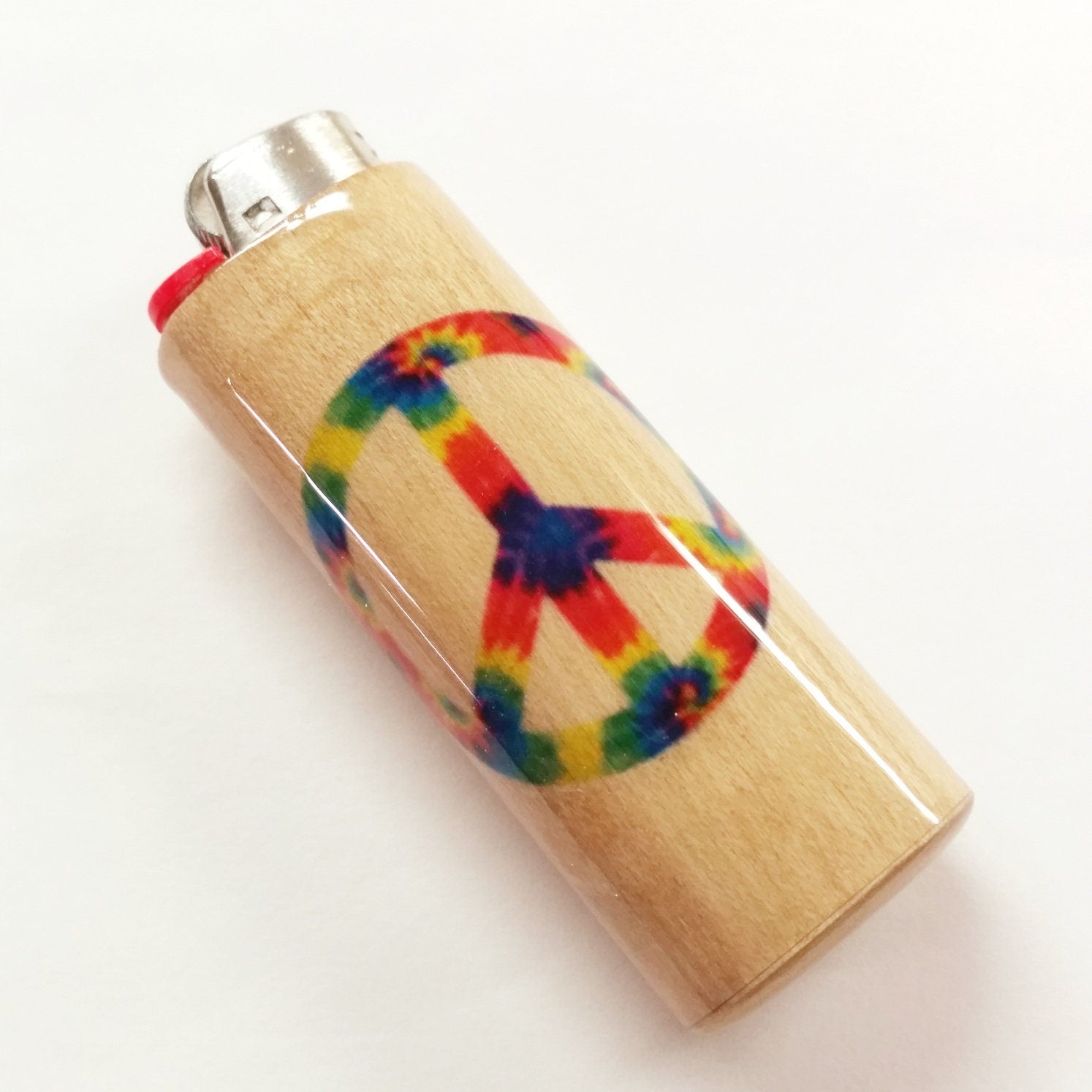 Lighter with a tie-dye peace symbol design on a white background