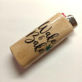 Wooden lighter with 'Wake & Bake' text and a cannabis leaf on a beige background