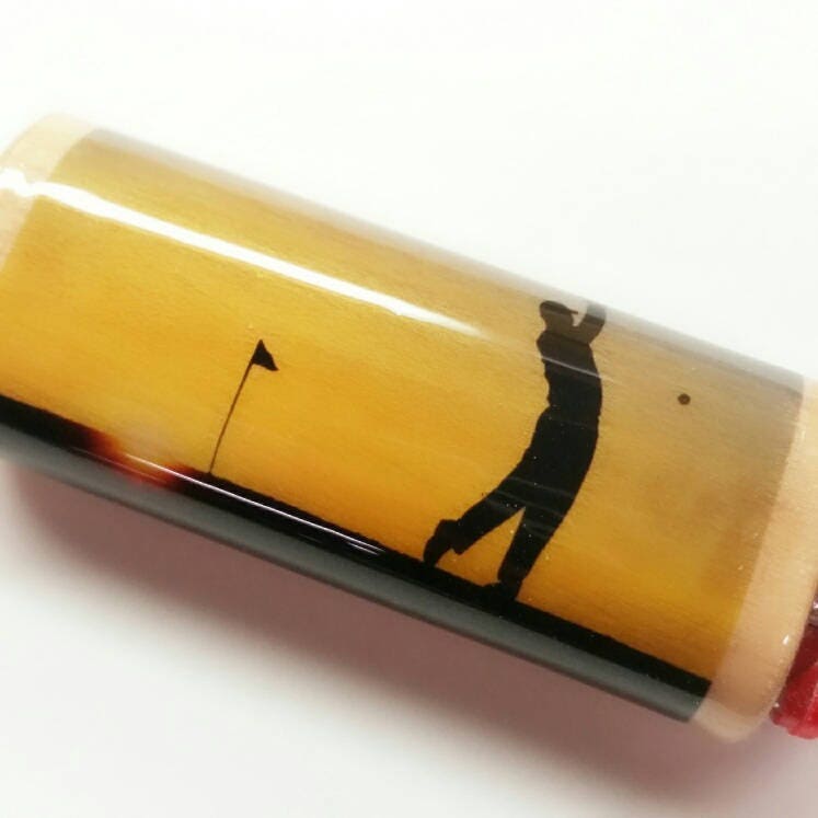 Golf-themed object with a silhouette of a golfer and flag on a yellow background