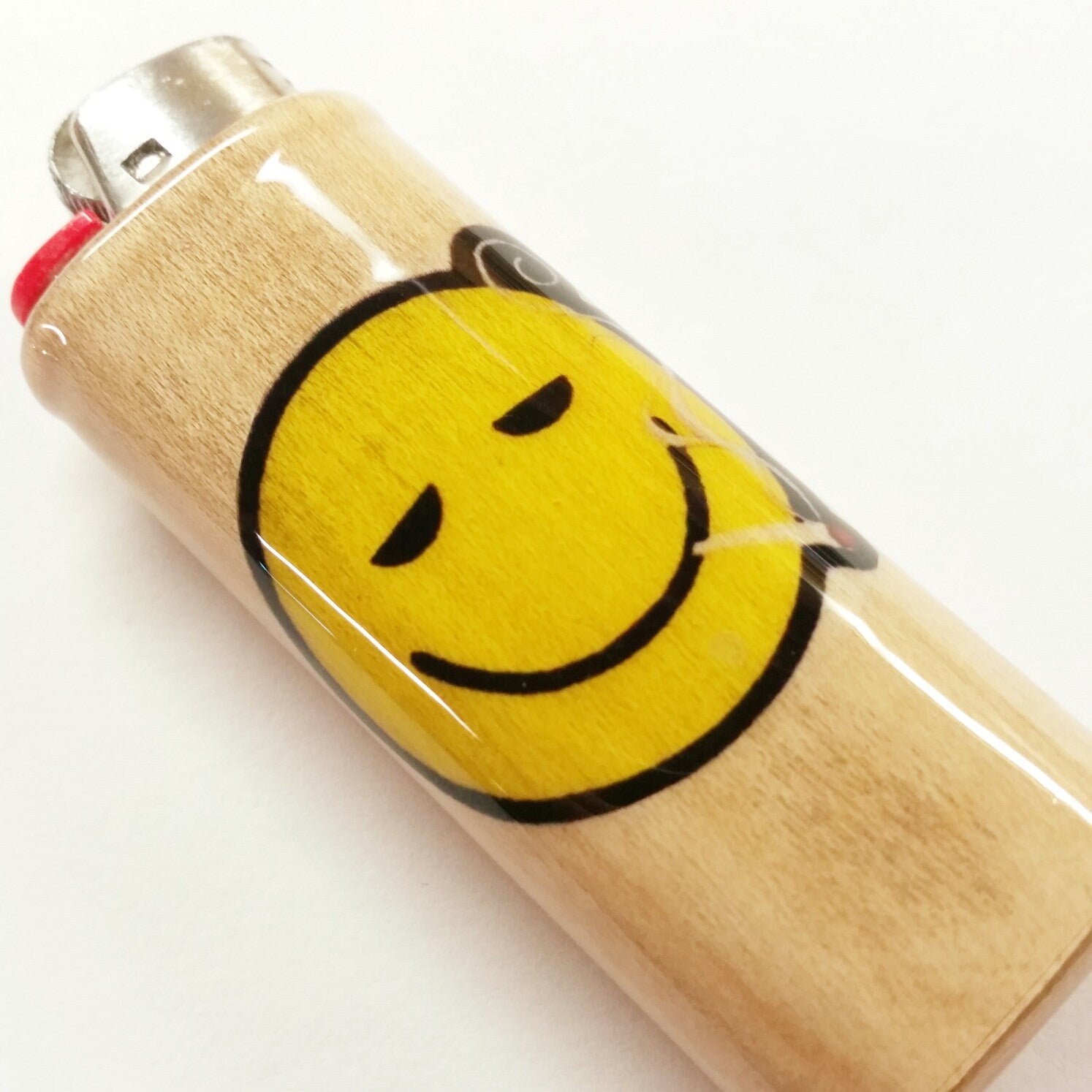 Lighter with a smiley face design on a white background
