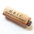 Lighter with 'H. B. I. C. HEAD BITCH IN CHARGE' text on a white background