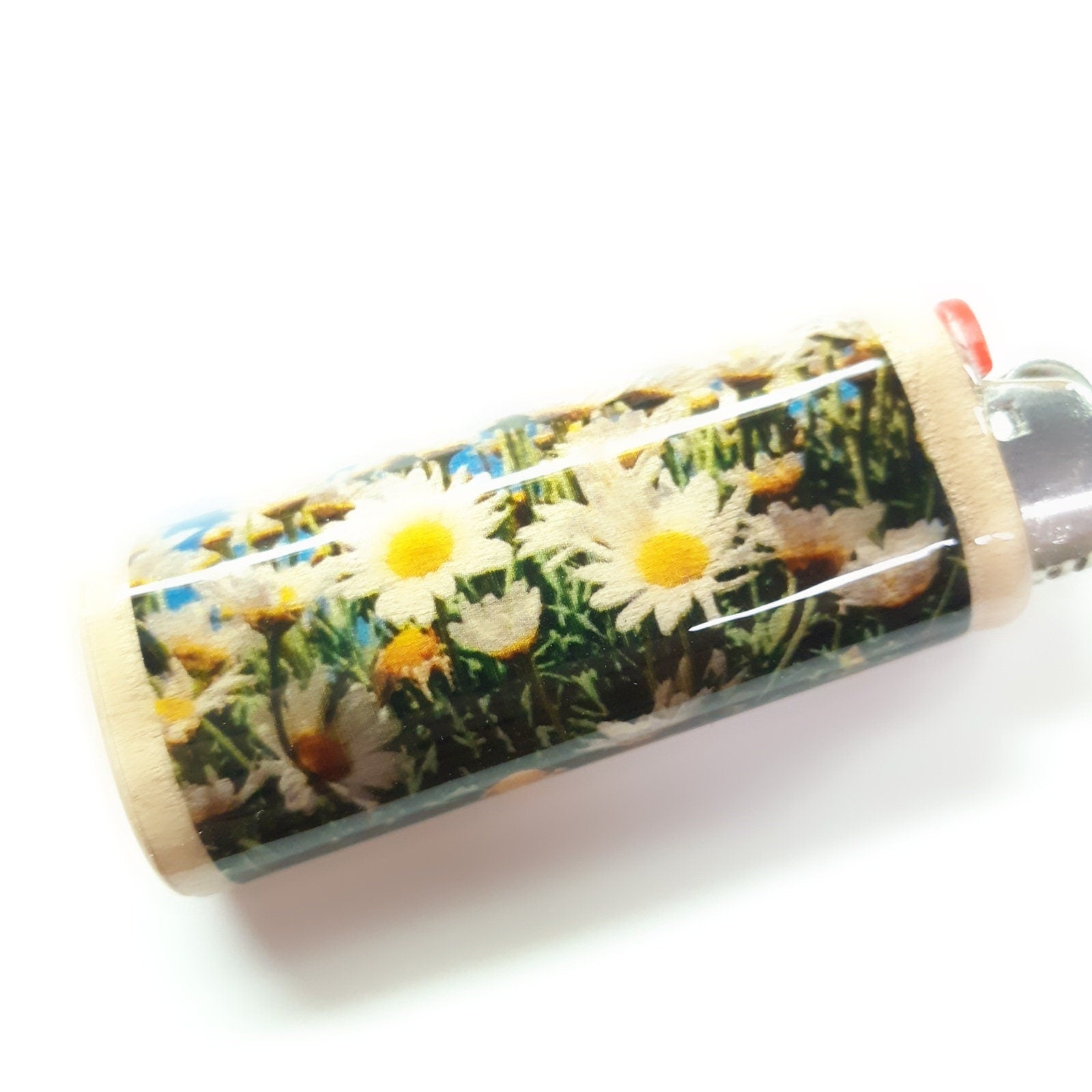 Lighter with daisy design on a white background
