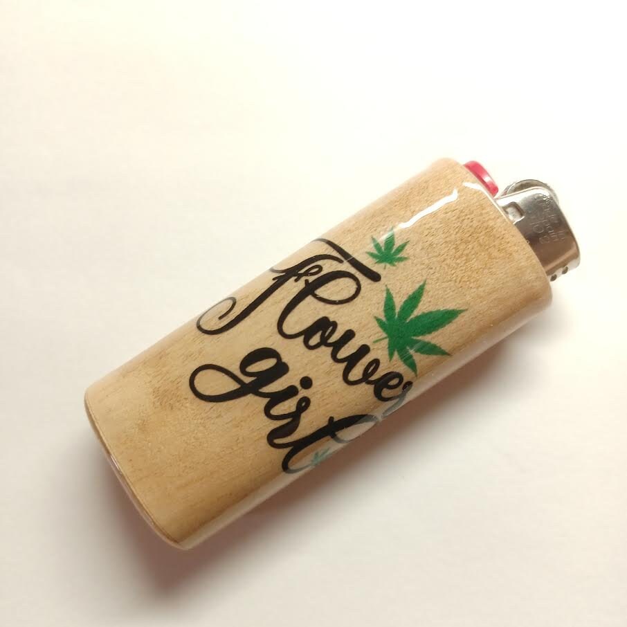 Lighter with 'Flower girl' text and cannabis leaf design on a beige background