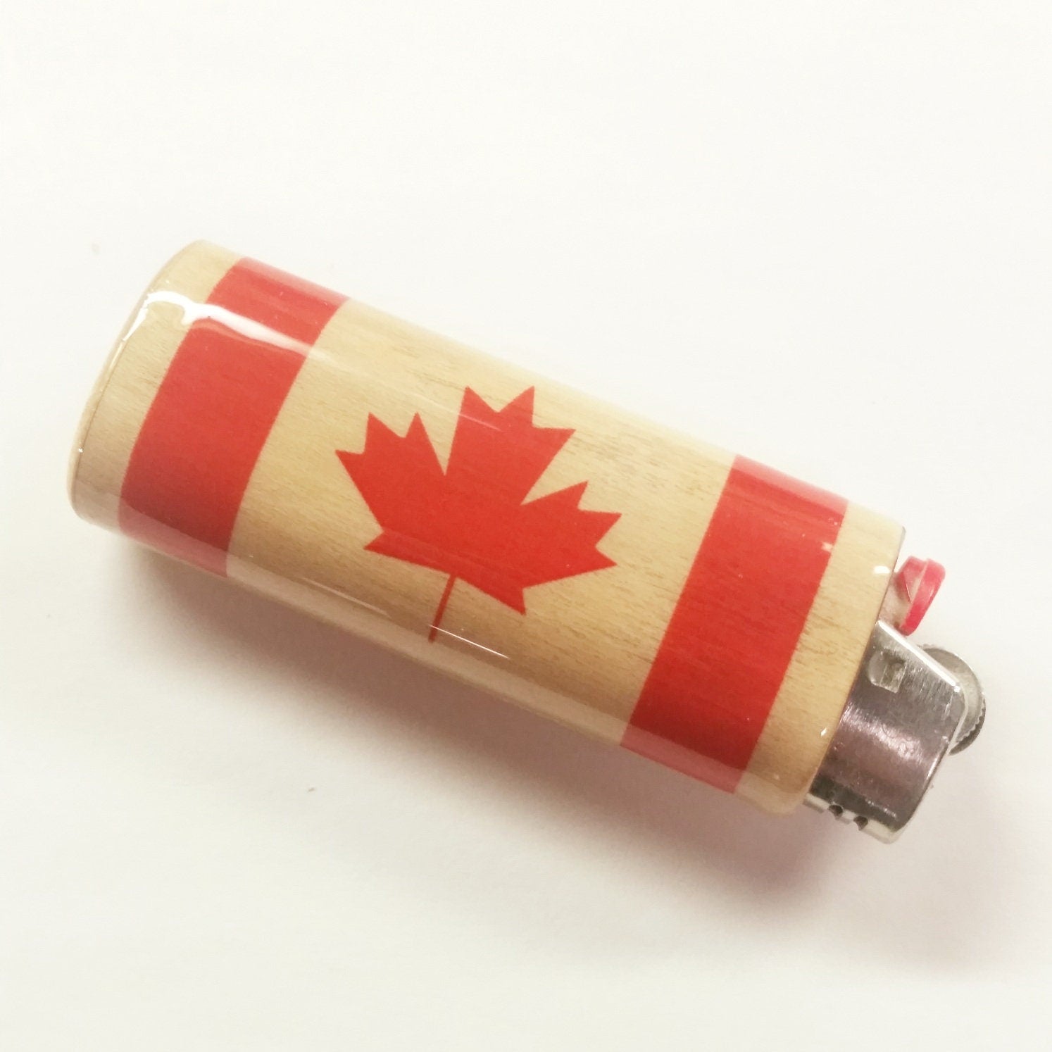 Lighter with a design of the Canadian flag on a white background