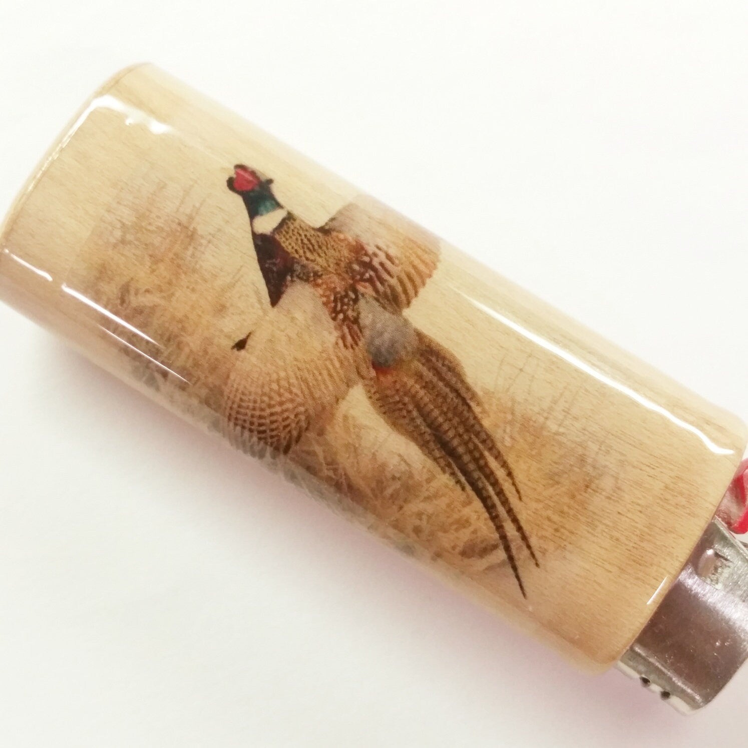 Lighter with a pheasant design on a white background