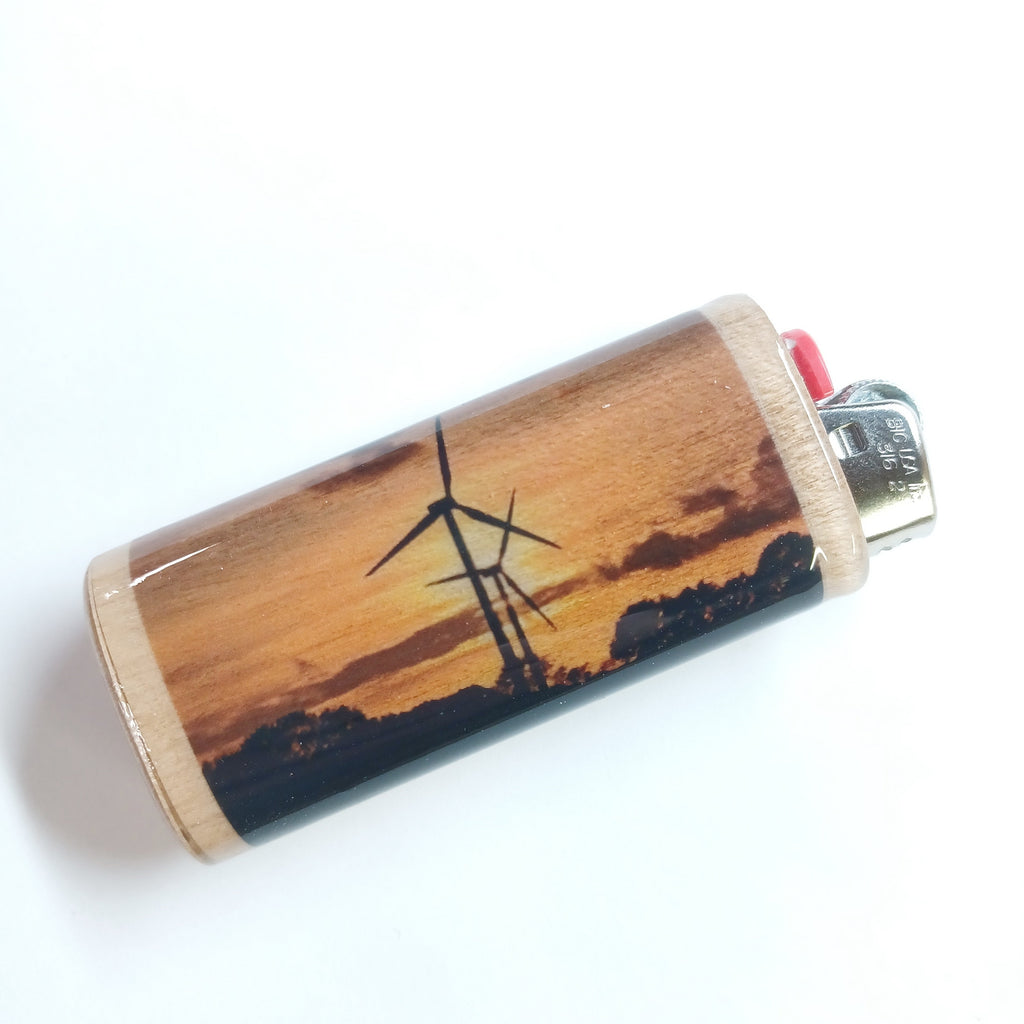 Lighter case with windmill design on a wooden surface