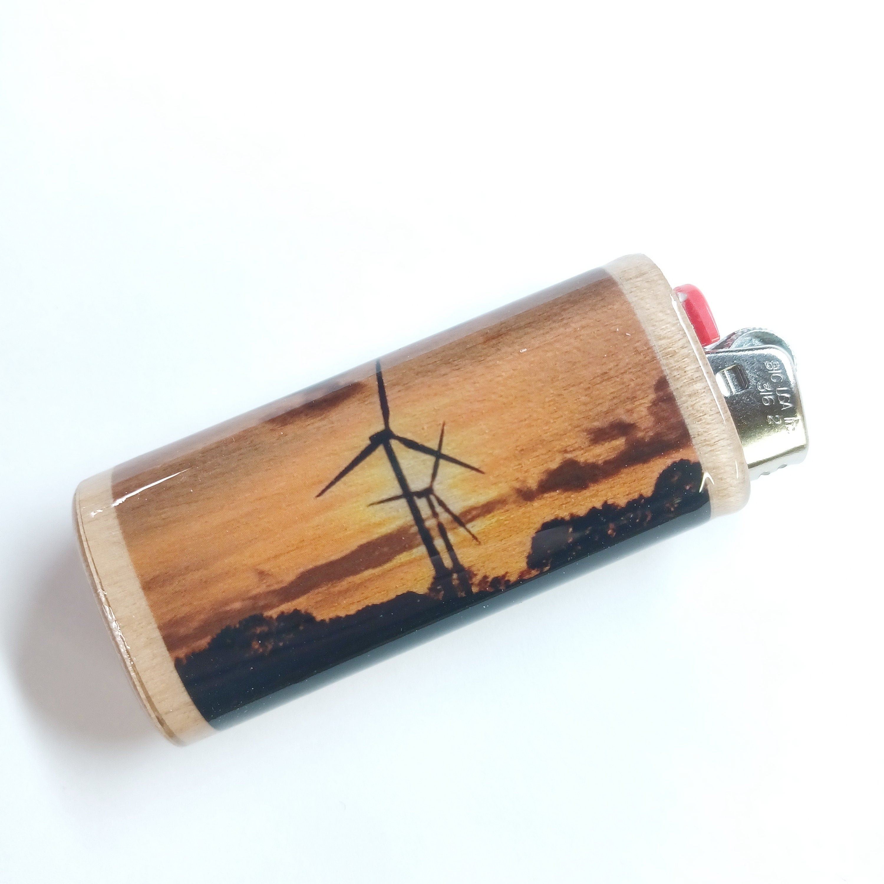 Lighter case with windmill design on a wooden surface