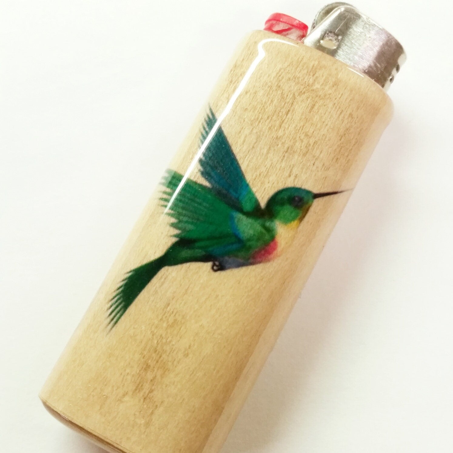 Lighter with a green hummingbird design on a white background