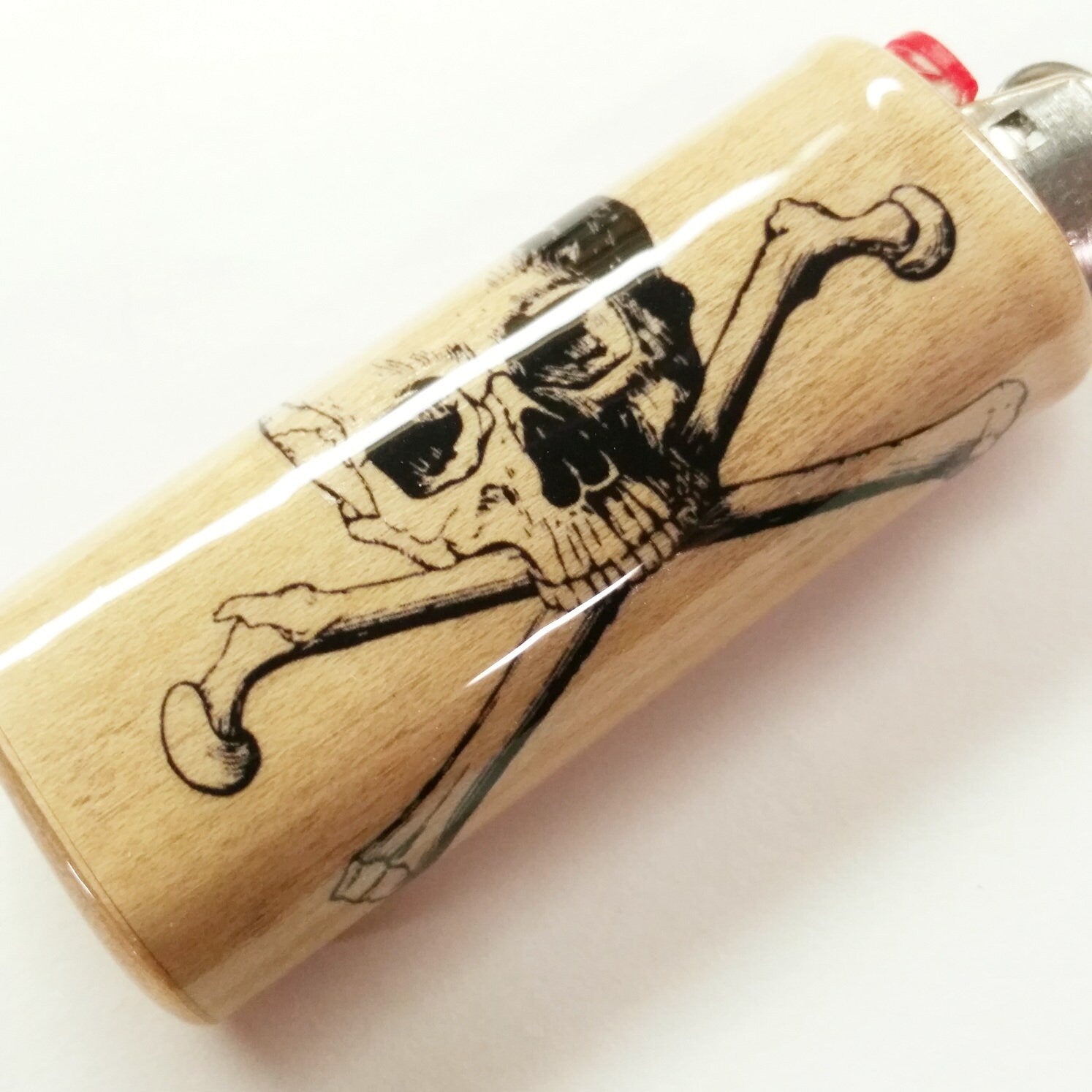 Wooden lighter with a skull and crossbones design on a white background