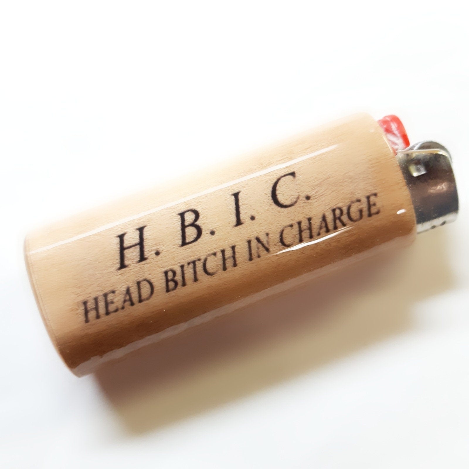 Lighter with 'H. B. I. C. HEAD BITCH IN CHARGE' text on a white background