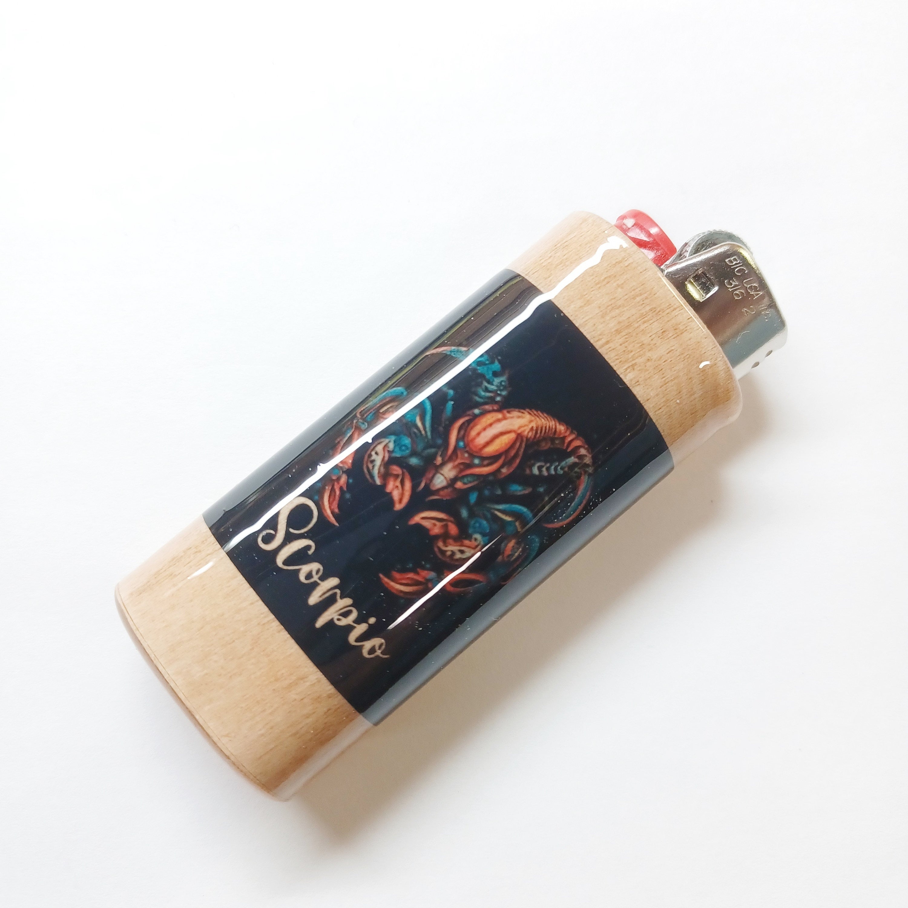 Lighter with Scorpio zodiac design on a white background