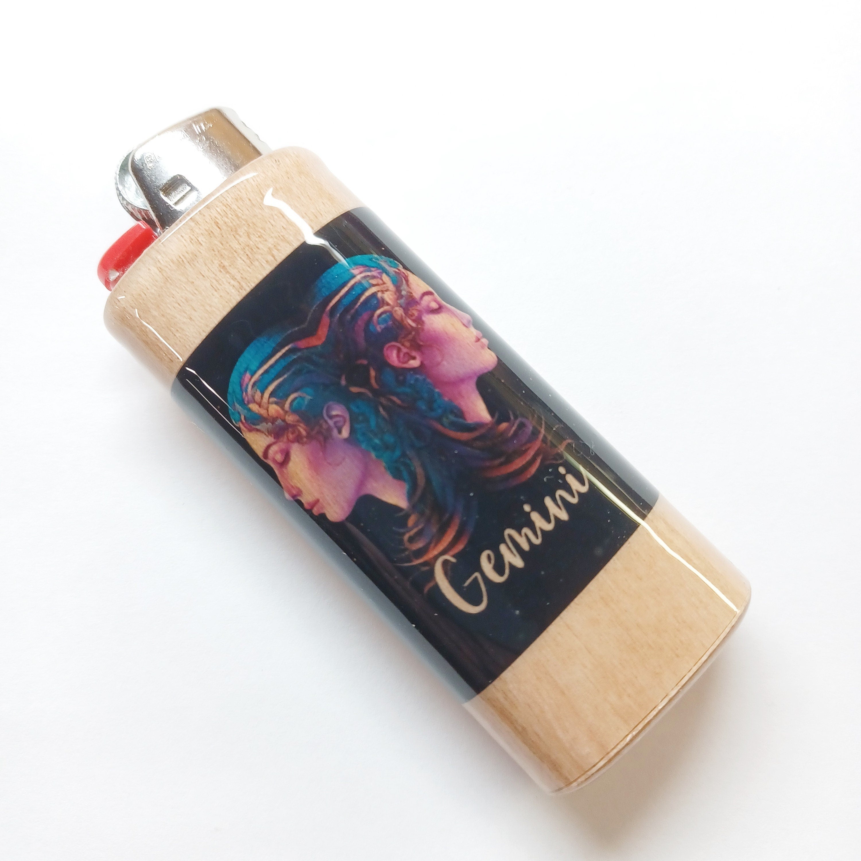 Lighter with a colorful design of a woman's face and the word 'Gemini' on a white background