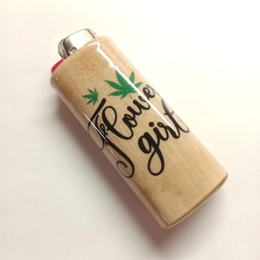 Lighter with 'Flower girl' text and a cannabis leaf design on a beige background