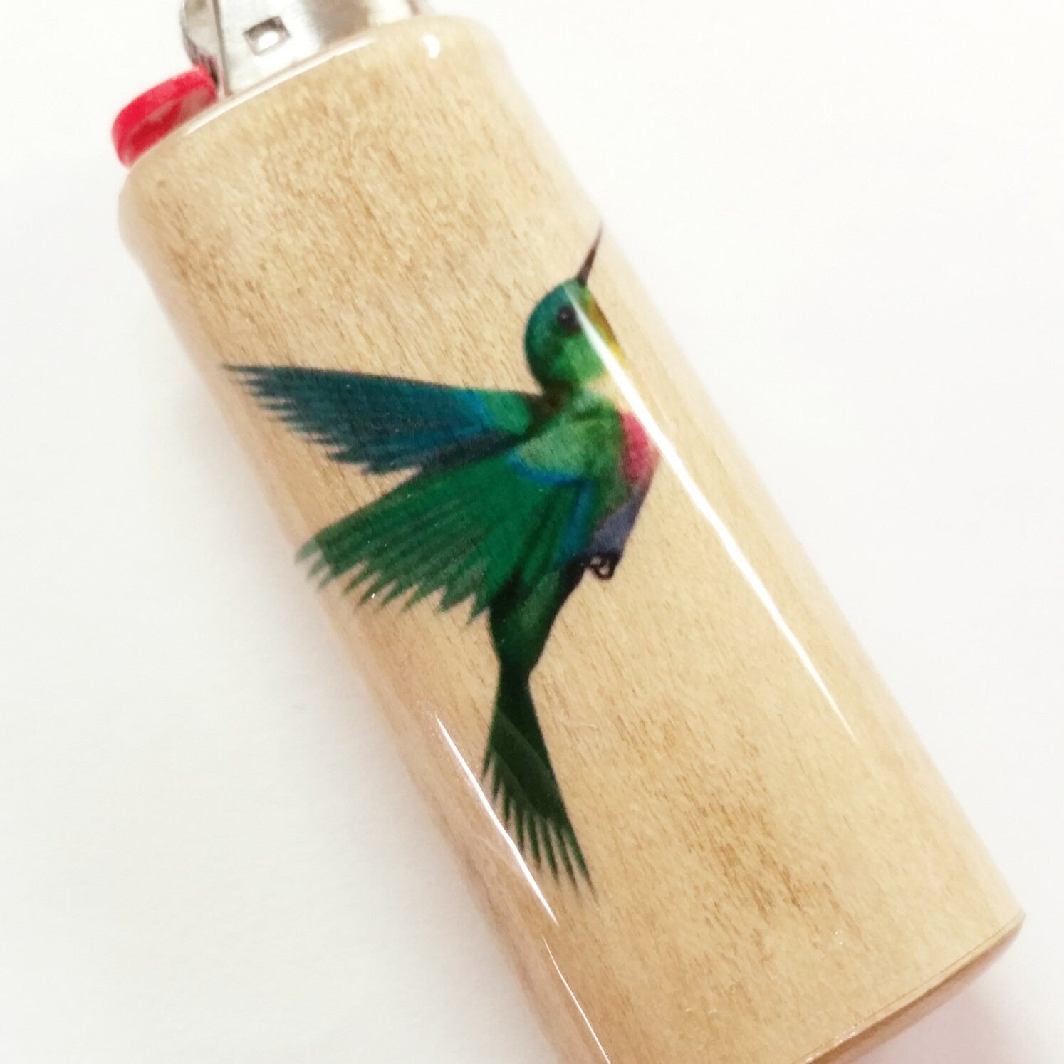 Lighter with a colorful hummingbird design on a white background