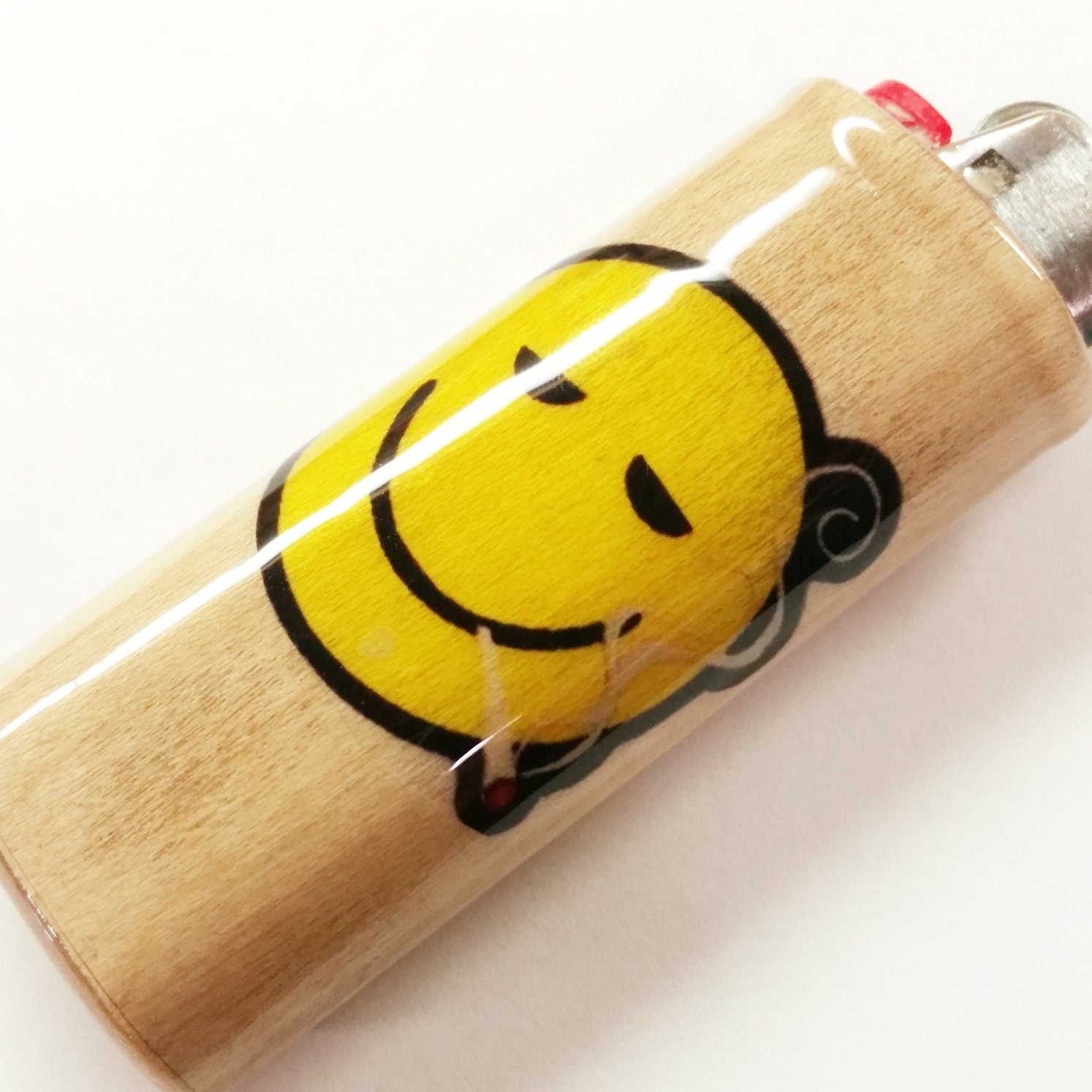 Lighter with a cartoon face design on a white background