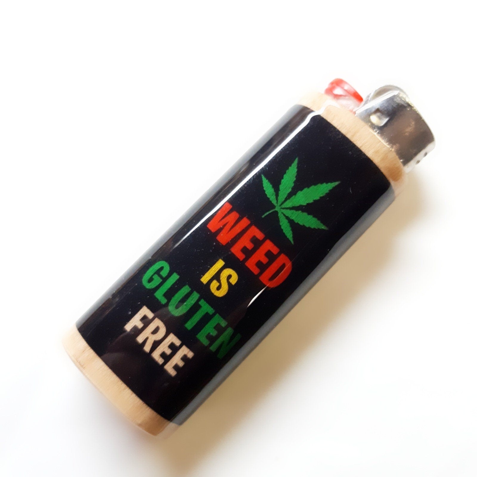 Lighter with marijuana leaf and text 'WEED IS GLUTEN FREE' on a white background
