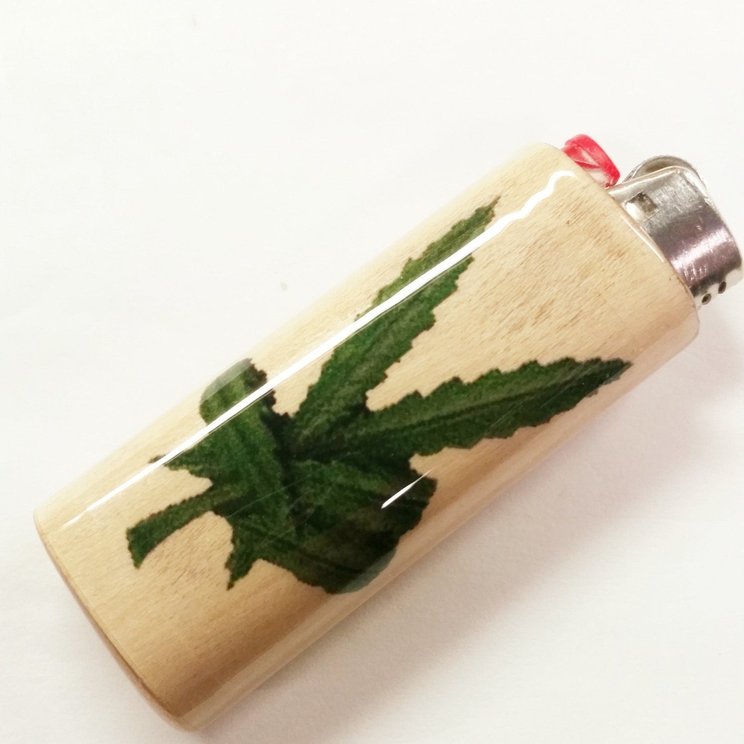 Lighter with a cannabis leaf design on a white background