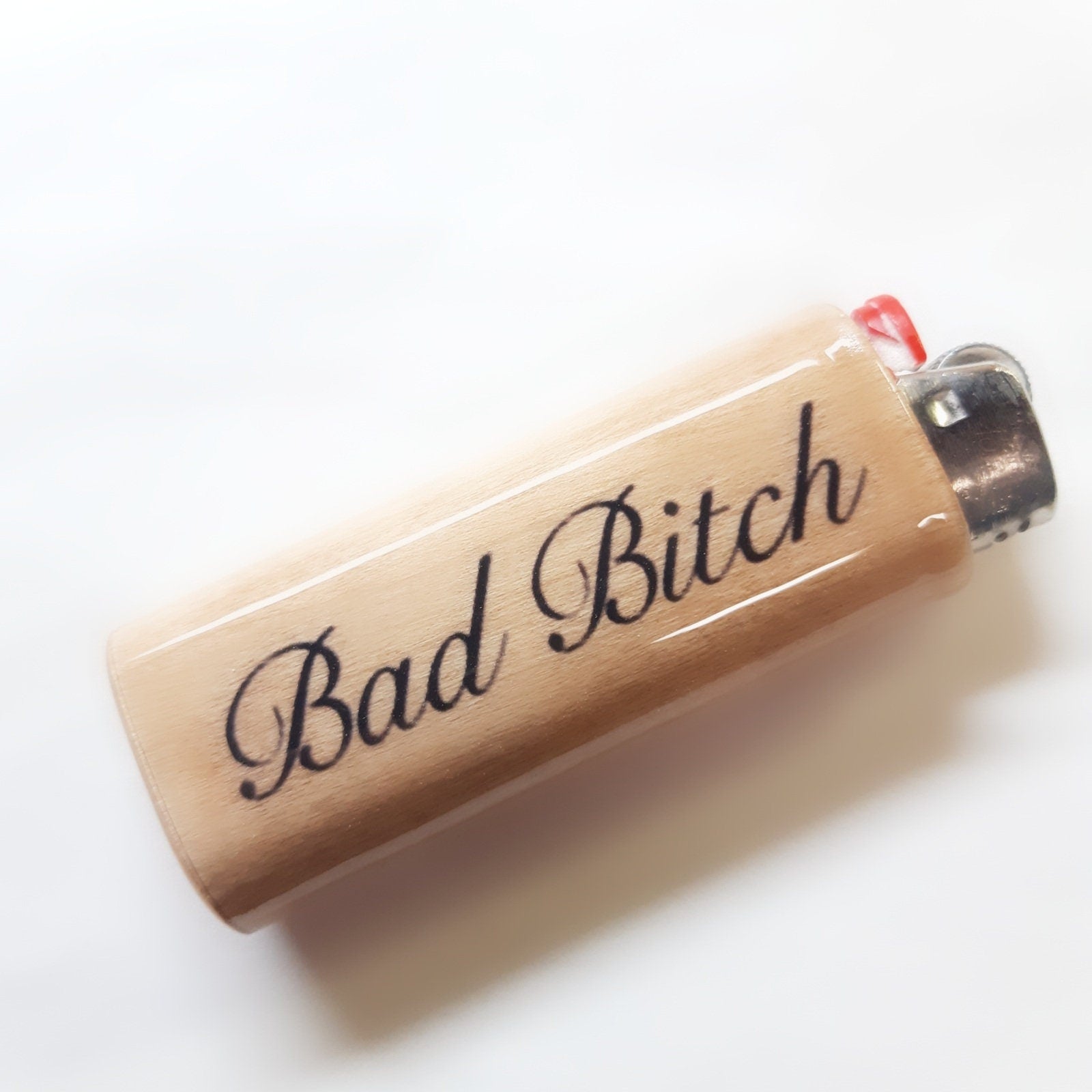 Lighter with 'Bad Bitch' text on a white background