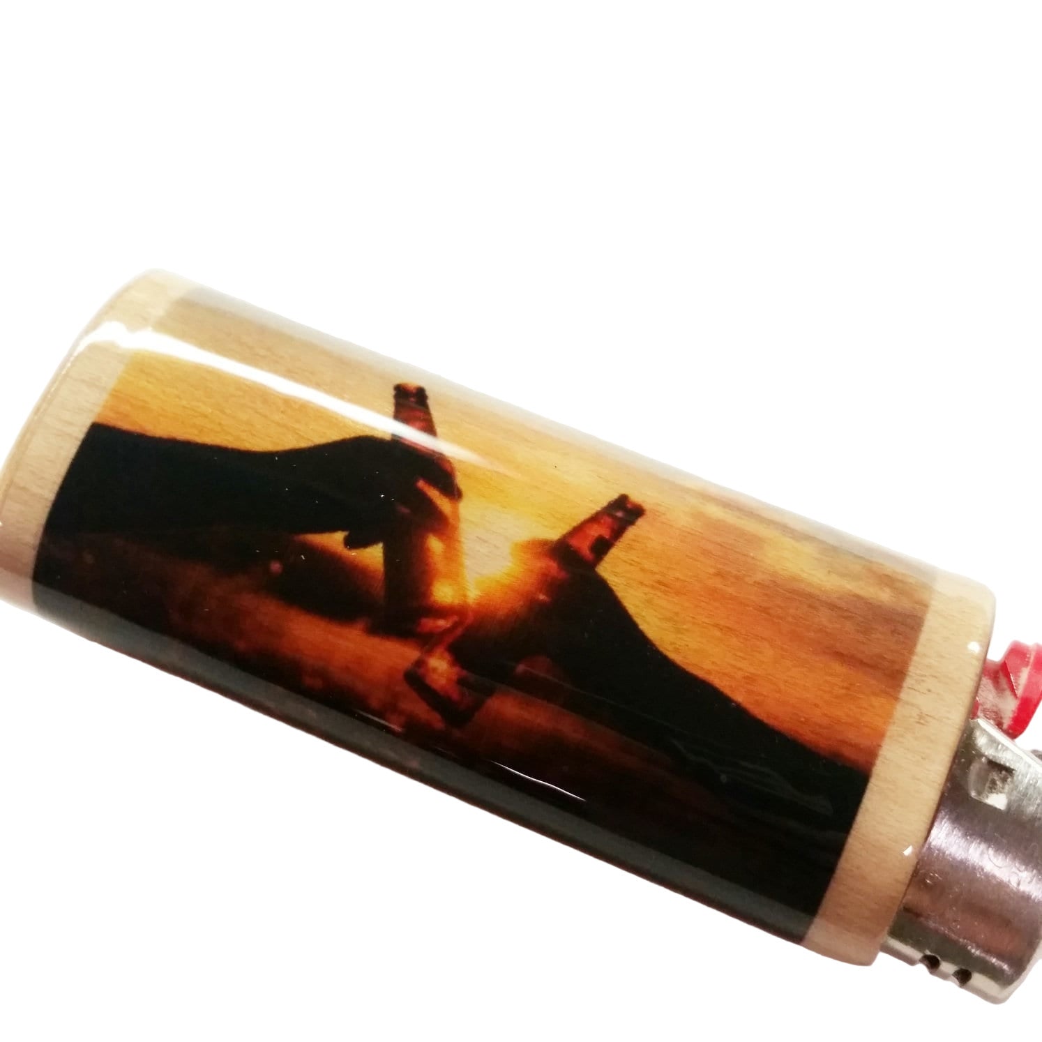 Lighter with a printed design of a hand holding a gun against a sunset background on a white surface.