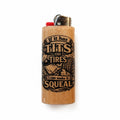A light wood lighter with a black graphic print that reads 'If it has TITS or TIRES I can make it SQUEAL' alongside illustrations of a tire and a hand on a wrench. It features a red ignition button and a silver metal top.
