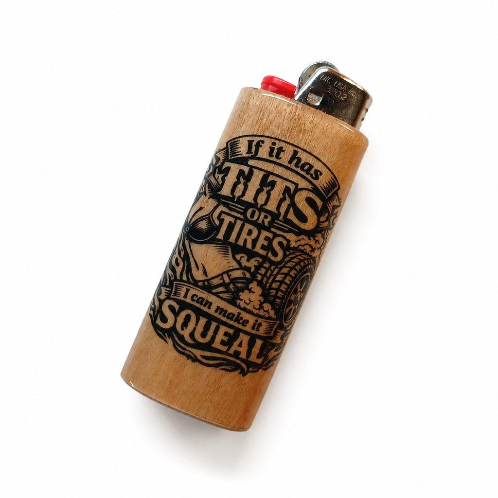 A wooden lighter with a natural light brown finish, featuring a black engraved graphic of a tire and the text 'If it has TIRES it can make it SQUEAL'. It has a red button and a silver metal ignition head, shown on a plain white background.
